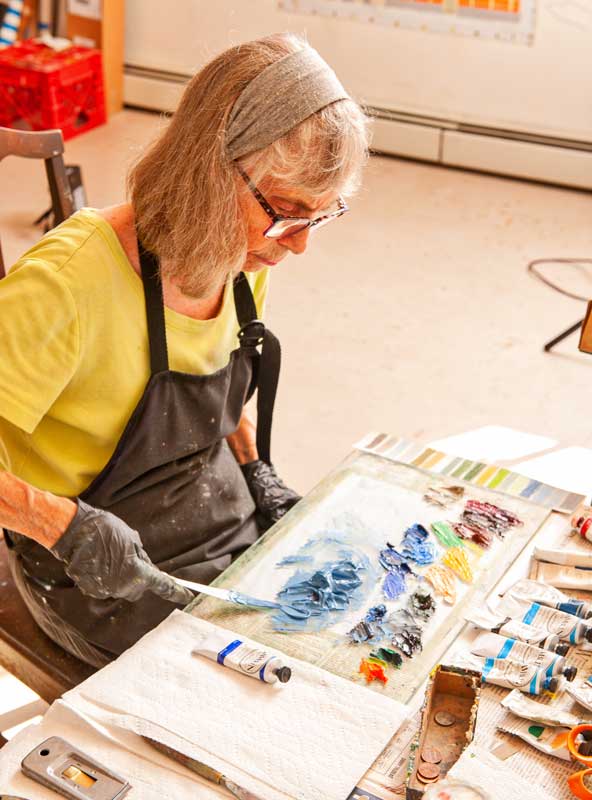 he painter prepares her palette in her Searsmont studio. Photo by Walter Smalling from At First Light: Two Centuries of Maine Artists, Their Homes and Studios, 2020