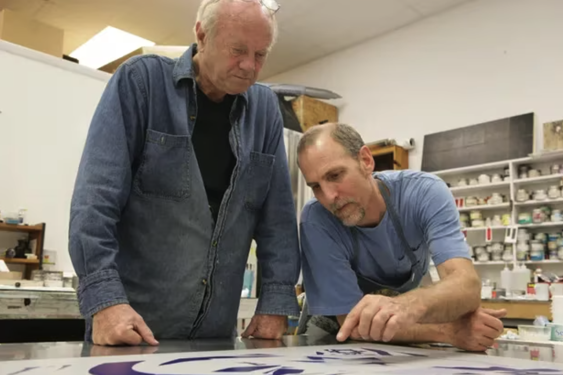 James Rosenquist, left, one of the leading proponents of the pop art movement, is shown here working with Tom Pruitt, the master printer and studio manager of Graphicstudio at the University of South Florida in Tampa. Rosenquist, who died in 2017, had a studio in Hernando County. [Graphicstudio]